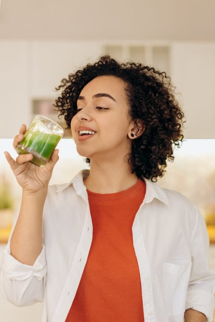 woman drinking a glass of fresh smoothie