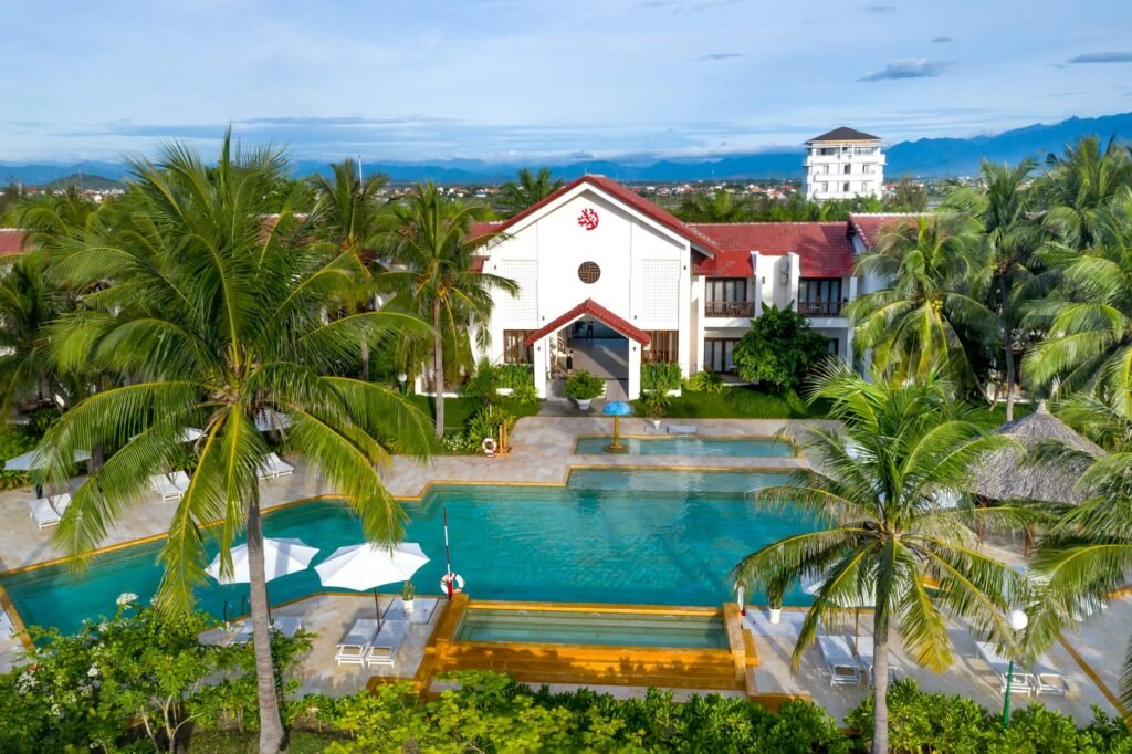 green palm trees beside the swimming pool