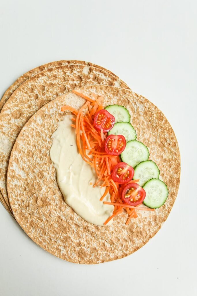 photo of sliced tomatoes on pita bread